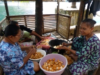 Ladies preparing the soft nutmeg shells to dry